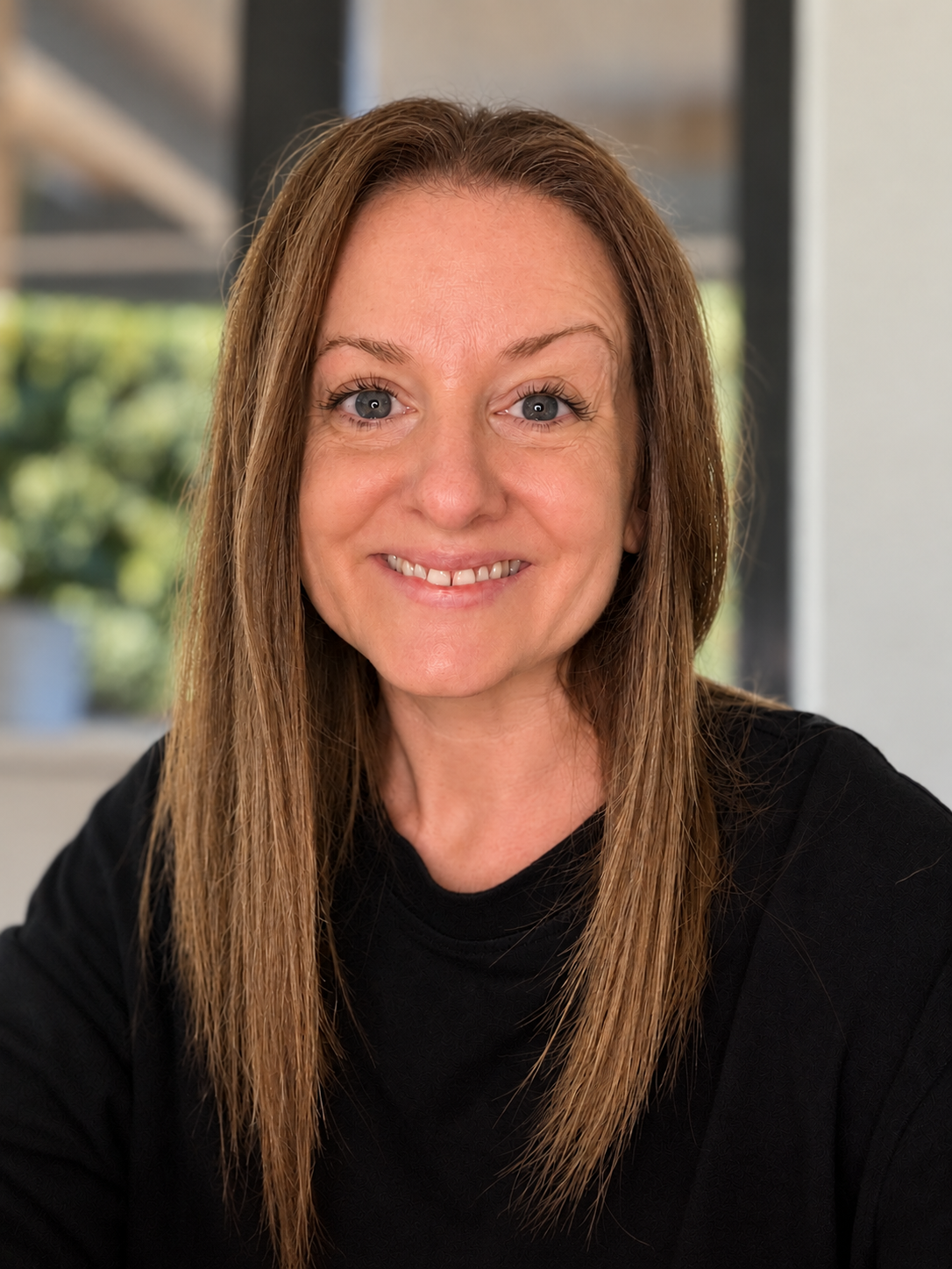 Jen Davidson, The Surrey Nutrition Coach, smiling in a black top